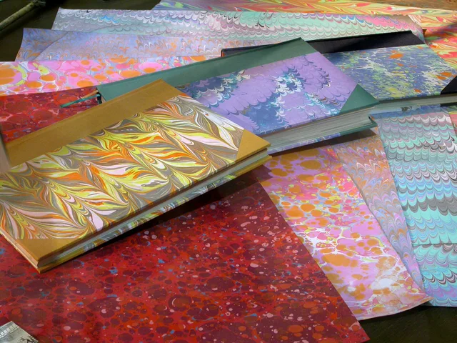 Handmade marbled paper sheets and book covers. From a display at the National University of La Plata ’s Public Library during the open-door museum night “Museos a la luz de la Luna” (‘Museums in the Moonlight’) on November 8, 2014. US arts grants for independent paper makers and book artists: tiers and application sequence